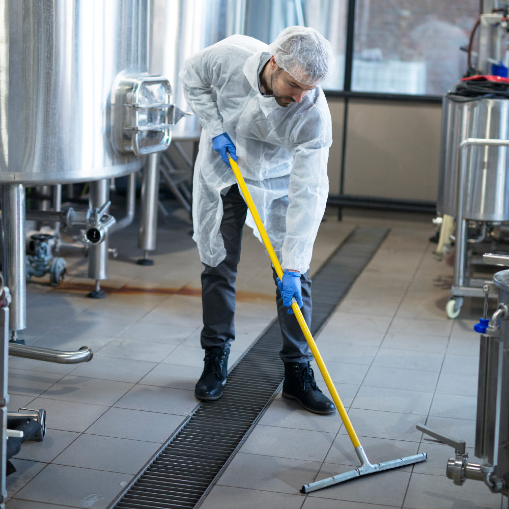 DuBois Industrial Strength Bleach Sanitizer SHS 900 - Man cleaning floor